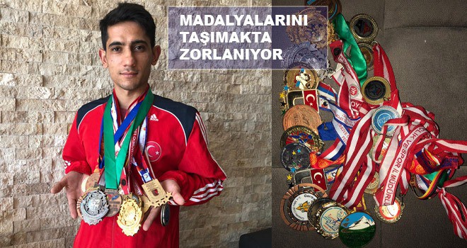 MADALYALARINI TAŞIMAKTA ZORLANIYOR